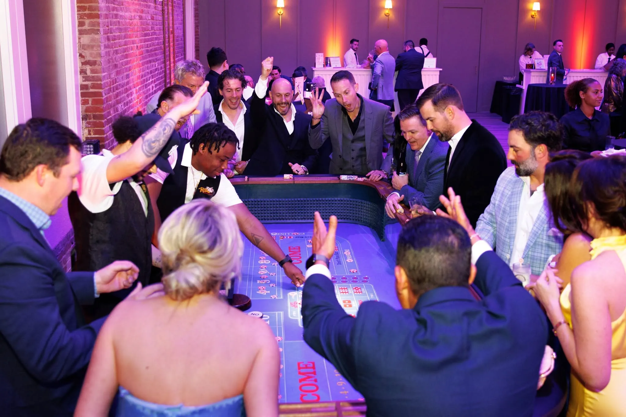 Guests gathered around the craps table